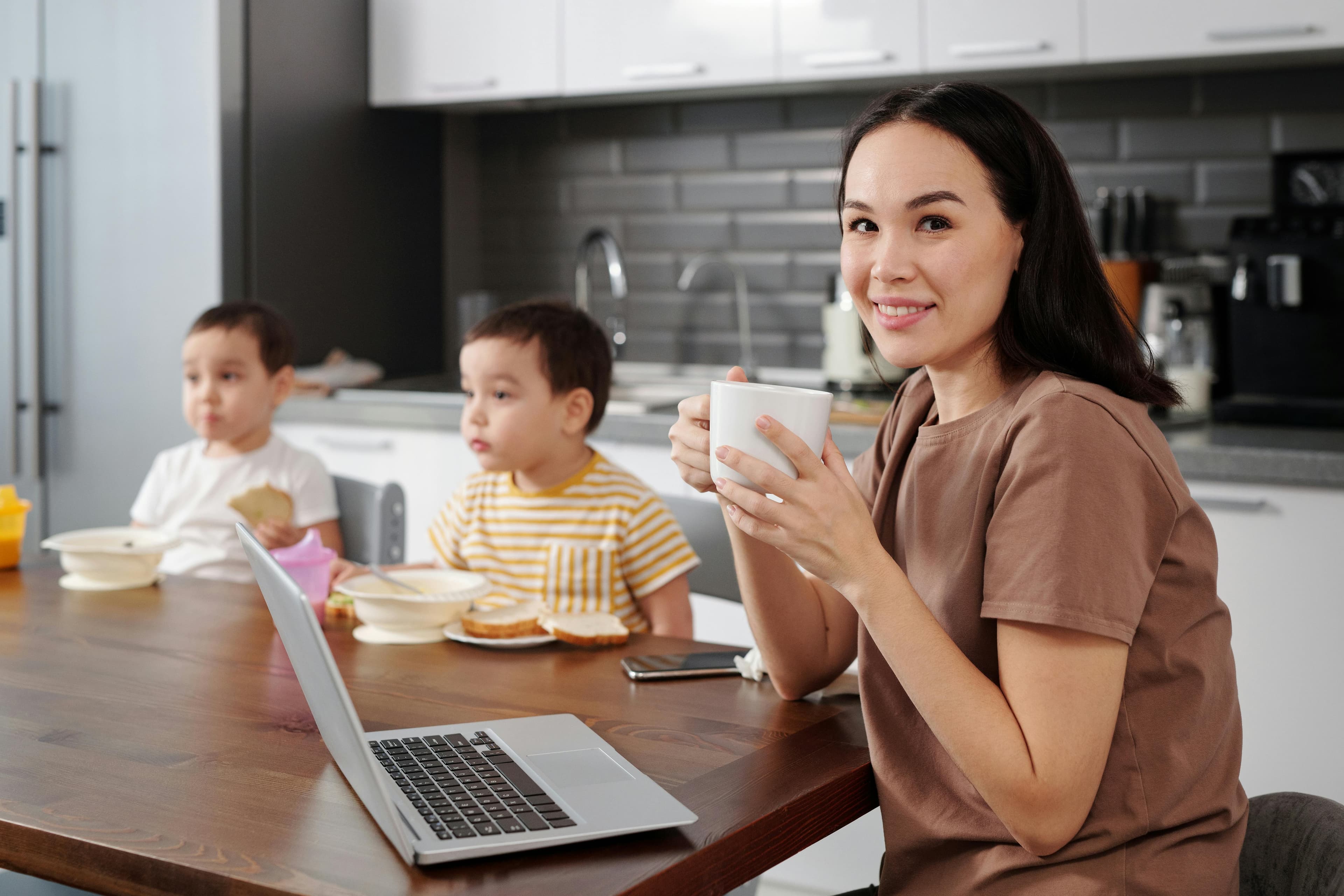 A calm moment — parent journaling with a warm drink